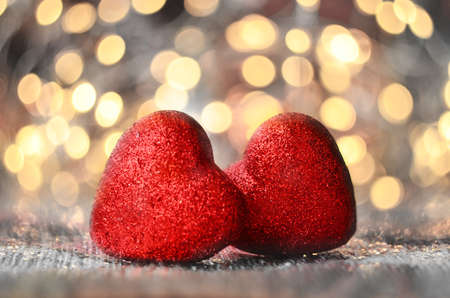 The red Heart shapes on abstract light glitter background in love concept for valentines dayの写真素材