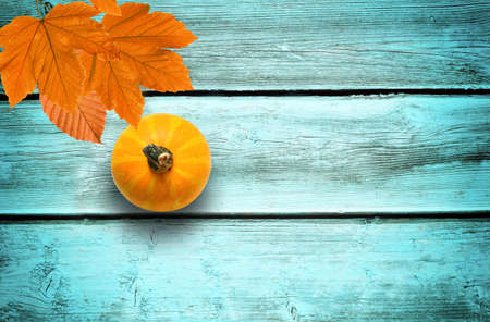Autumn background of fall leaves on the blue wooden board, top view.の写真素材