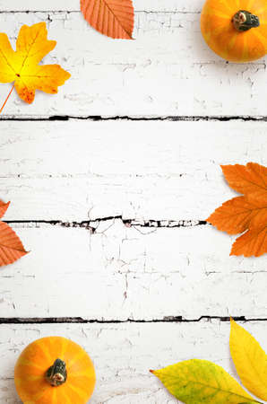 Autumn background of fall leaves on the wooden board, top view.の写真素材