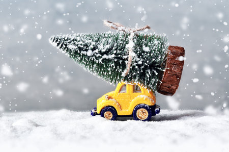 Christmas tree on toy car. Christmas holiday celebration concept.の写真素材