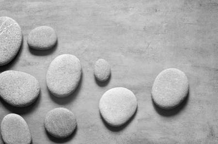 Flat lay composition with grey spa stones on grey background.の写真素材