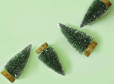 Simple wooden fir christmas trees on green background. Creative concept.の写真素材