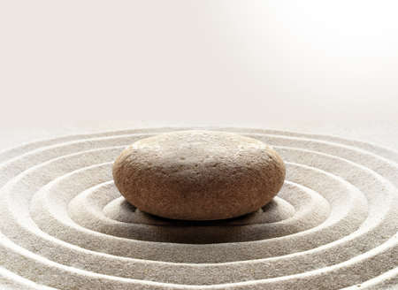 zen garden meditation stone background with stones and lines in sand for relaxation balance and harmony spirituality or spa wellness.の写真素材