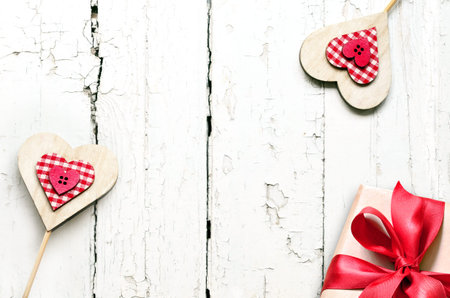 Valentines Day gift boxes with heart on white wooden background, top view with copy space.