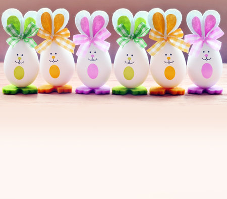 Group Easter eggs with the Bunny ears on pink background. Easter concept.