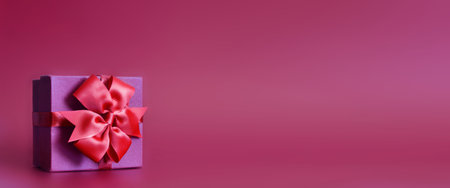 Holiday concept banner with hand made gift box, bow on a purple background with space for text