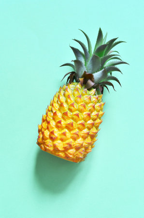 Yellow pineapple on a blue background. Exotic concept.の写真素材