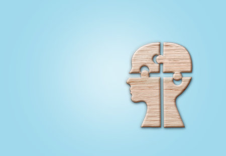 Human head silhouette with a jigsaw piece cut out on the blue background, mental health symbol.の写真素材