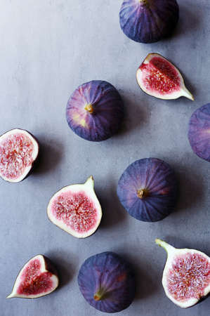 Fresh figs on violet background. Beautiful blue violet figs. Flat lay.の写真素材