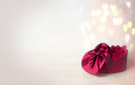 Valentines day concept with gift box over heart shaped bokeh. Holiday concept.