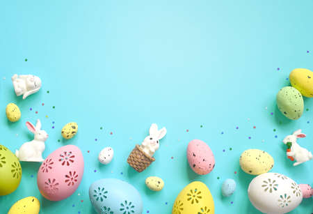 Easter composition. Easter eggs and easter bunny on pastel blue background. Minimal concept of Easter. Flat lay, top view, copy spaceの写真素材