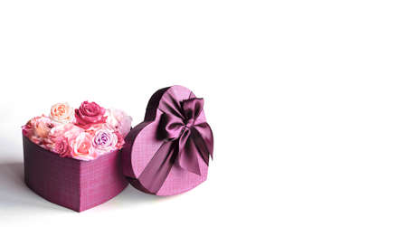 Heart shape gift box and bouquet. Flowers a gift in the shape of a heart. Roses in a box heart on white backgroundの写真素材