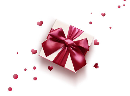 Top view photo of valentine's day decorations white gift box with red ribbon bow and small hearts on isolated white background with empty space.の写真素材