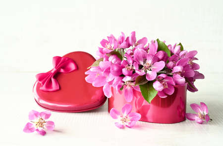 Heart shape gift box and bouquet. Flowers a gift in the shape of a heart. Flowers in a box heart on white background. holiday concept.の写真素材