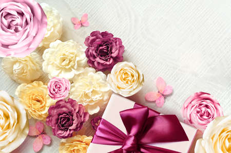 Colorful roses and gift box on white background. Beautiful, good for holidays and gift. flowers pattern.の写真素材
