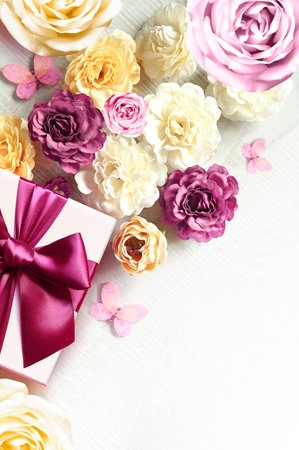 Colorful roses and gift box on white background. Beautiful, good for holidays and gift. flowers pattern.の写真素材