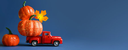 Retro truck with pumpkins and leaves on blue background. Concept of Thanksgiving day, Halloween and...