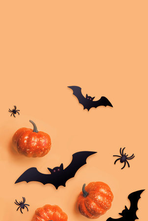 Orange Halloween background. Black bats and orange pumpkins. autumn decoration. Halloween concept. top view.の写真素材