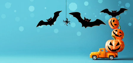 Truck loaded with many beautiful orange pumpkins and bats. Preparing for the scary Halloween holidayの写真素材