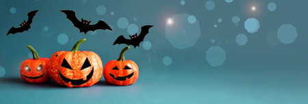 Halloween pumpkins and black bats on blue background. Halloween concept.の写真素材