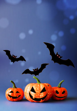 Halloween pumpkins and black bats on blue background. Halloween concept.の写真素材