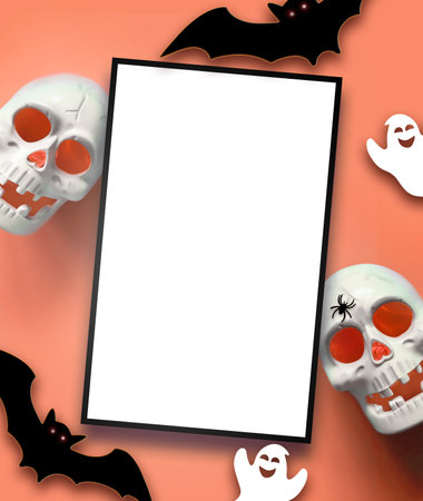 Halloween decorations on orange background. Happy Halloween concept. Flat lay pumpkins, scull, bats, ghosts and spidersの写真素材