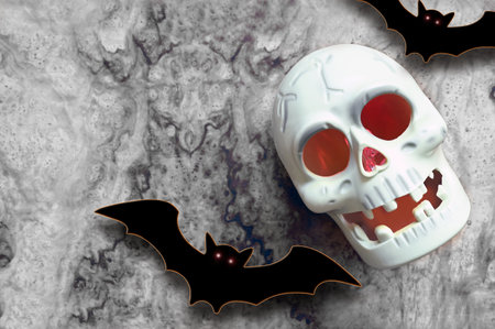 Halloween skull and decorations on gray background. Flat lay bats and skull. halloween greeting cardの写真素材