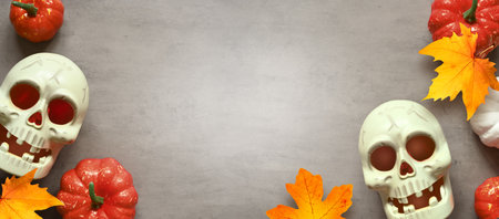 Holidays, decoration and party concept -scull and pumpkin halloween over gray background.の写真素材