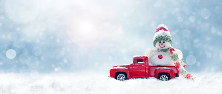 New year christmas snow concept. happy holiday celebration. Christmas and transport. Snowman winter with toy truck.の写真素材