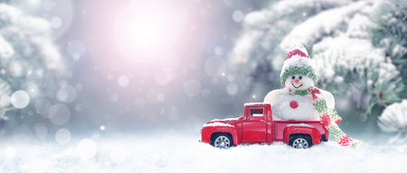 New year christmas snow concept. happy holiday celebration. Christmas and transport. Snowman winter with toy truck.の写真素材