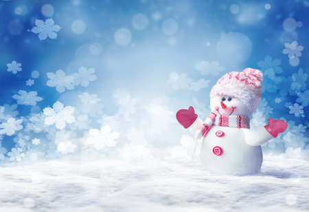 Merry christmas and happy new year greeting card. Happy snowman standing in winter christmas landscape.Snow backgroundの写真素材