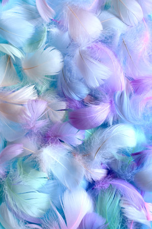 Angelic Pastel tinted White feather background - small fluffy blue feathers randomly scattered forming a background.の写真素材