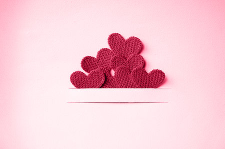Small red hearts on a pink background with copy space. Valentine's day concept. Viva magenta color,の写真素材