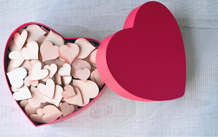 Open pink heart shaped gift box with hearts on gray background. Design for Valentine's Day.の写真素材