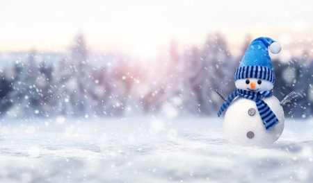 One little snowmen in caps on snow in the winter. Festive background with a funny snowman. Christmas card, copy space.の写真素材