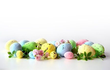 Collection of stylish colors eggs with flowers for Easter celebration on white background. Holiday concept.の写真素材