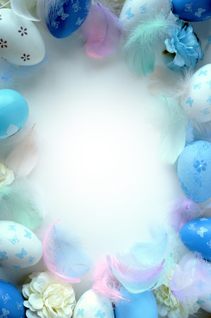 Easter decorations concept. Top view photo of colorful easter eggs, flowers and blue feathers on isolated pastel blue background.の写真素材
