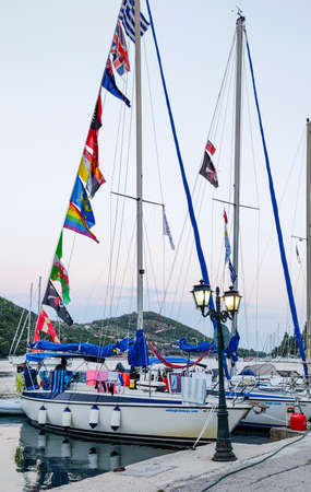 Yachts on the dock in a small marina in greeceの写真素材