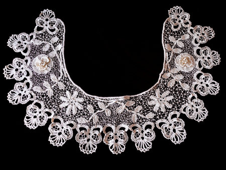 White handmade bobbin lace with dark background