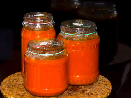 Glasses of homemade fruit jams on a wooden trayの写真素材
