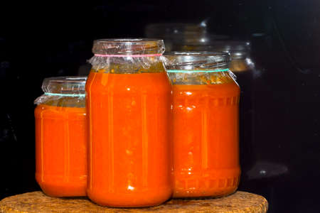 Glasses of homemade fruit jams on a wooden trayの写真素材