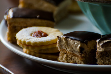 Walnut cream cakes and linzer cookies on a plate