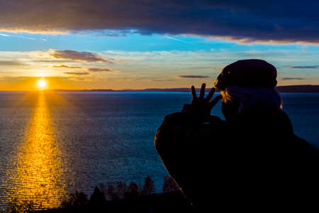 An old man at sunset from the hill at Balatonakarattya in winterの写真素材