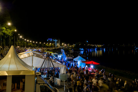 SZEGED, HUNGARY - SEPTEMBER 9, 2022: Crowd in the International Tisza Fish Festival in Szeged at nightのeditorial素材