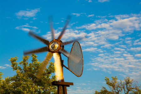 Tin pinwheel at late afternoon in windy weatherの写真素材