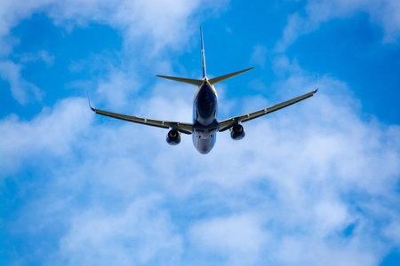 Boeing 737 airplane is taking off under the cloudy sky