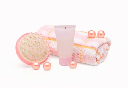 massager, cream tube and towel on white backgroundの写真素材