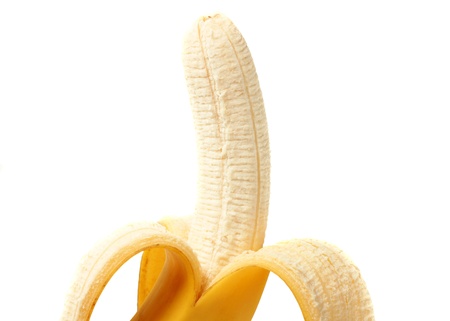 A partly peeled banana isolated on whiteの写真素材