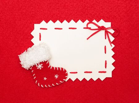 Christmas empty postcard  and Christmas stocking on red background の写真素材