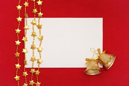 Christmas card:  blank, two  christmas bells and garlands  on red backgroundの写真素材